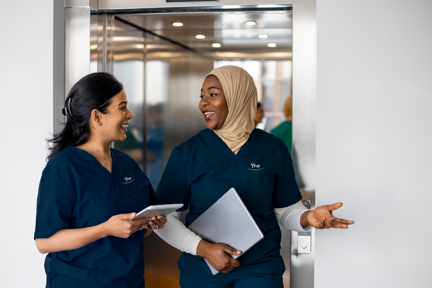 Two colleagues talking as they head into a shift